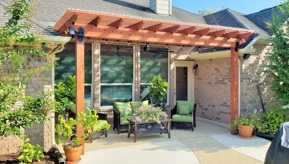 Photo of a mid-sized backyard patio in Houston with a pergola.