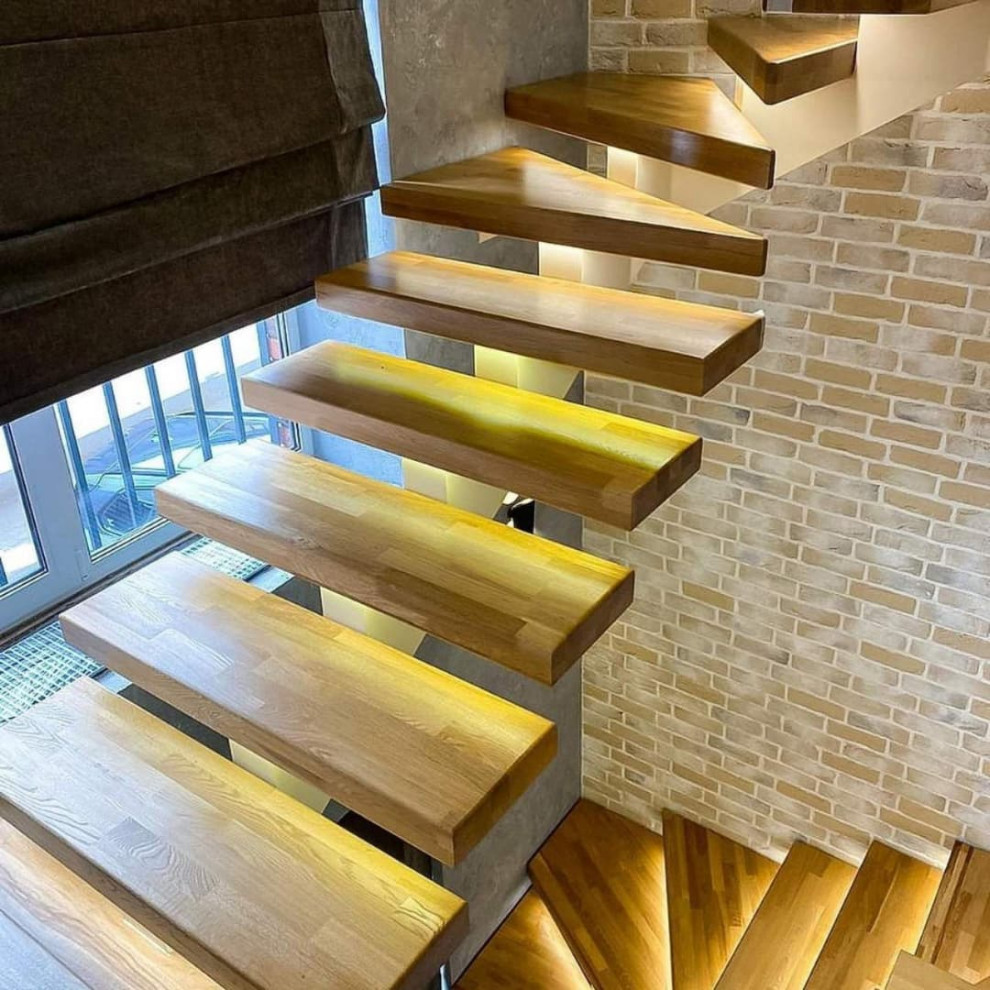 Inspiration for a medium sized farmhouse wood u-shaped staircase in Moscow with wood risers.