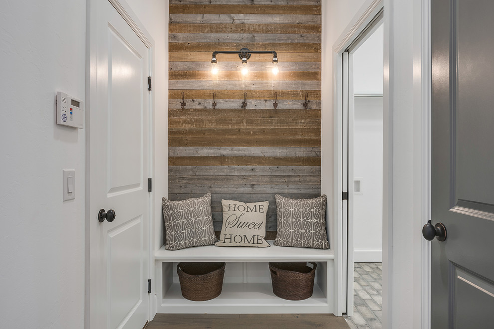 This is an example of a transitional mudroom in Oklahoma City with white walls, dark hardwood floors, a single front door and a white front door.