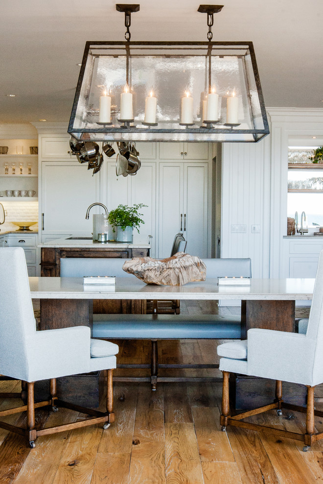 Design ideas for a beach style open plan dining in Orange County with white walls and medium hardwood floors.