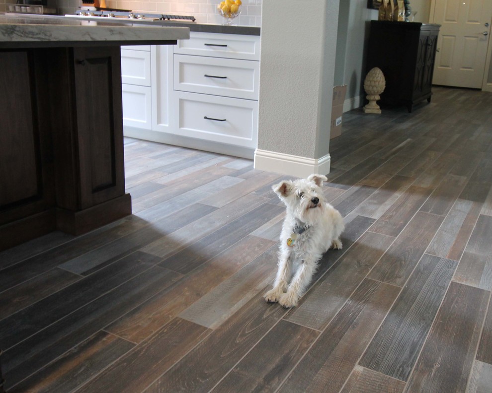 Example of a mid-sized transitional l-shaped porcelain tile open concept kitchen design in Sacramento with an undermount sink, shaker cabinets, gray cabinets, quartzite countertops, gray backsplash, ceramic backsplash, stainless steel appliances and an island