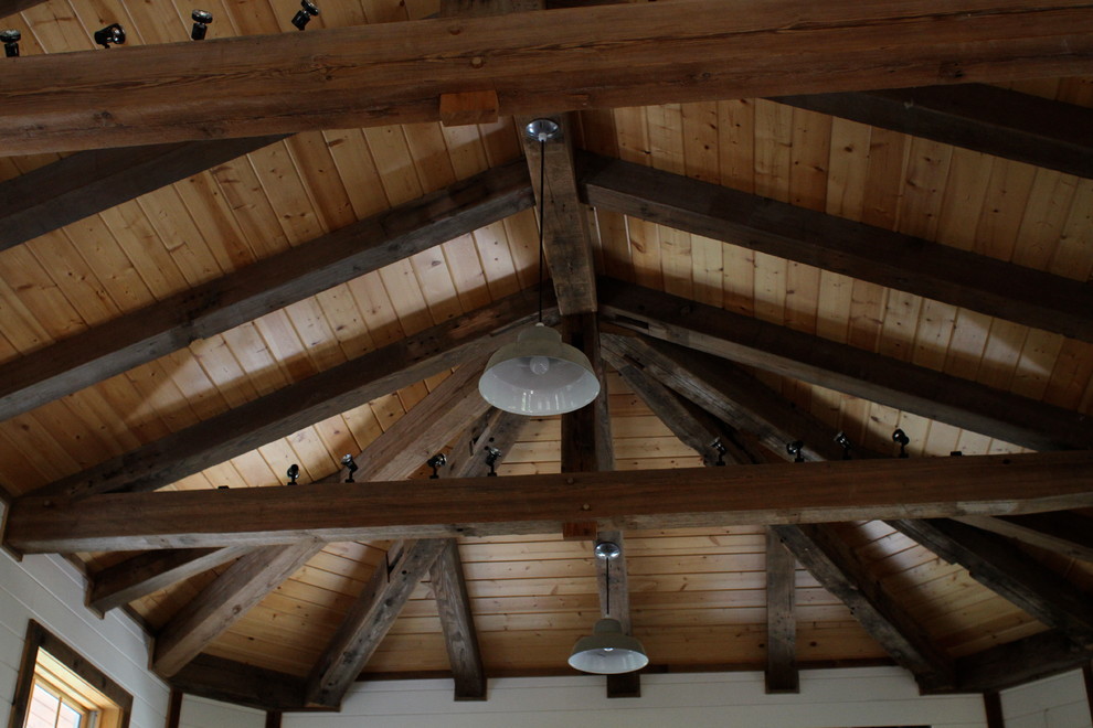 Inspiration for a large rustic master bedroom remodel with white walls