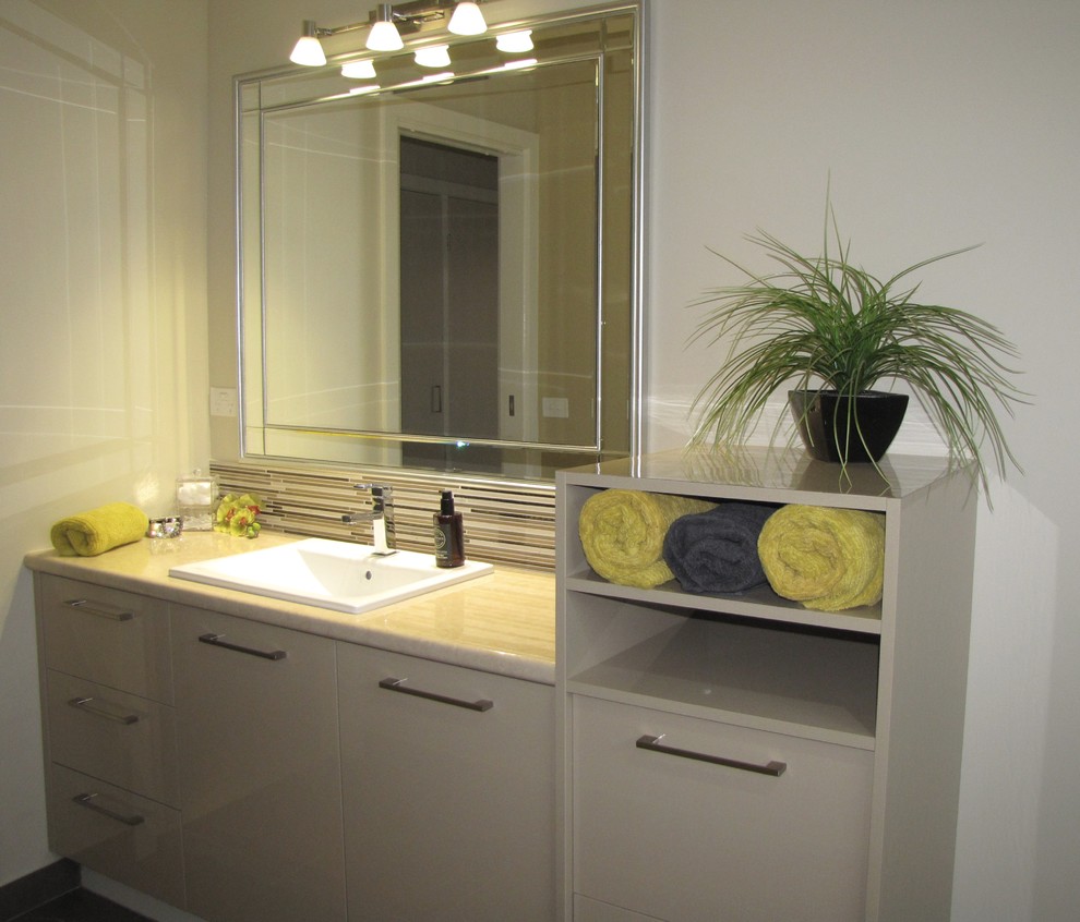 Inspiration for a mid-sized contemporary bathroom in Melbourne with shaker cabinets, beige cabinets, a freestanding tub, an open shower, beige tile, ceramic tile, beige walls, ceramic floors, a drop-in sink and laminate benchtops.