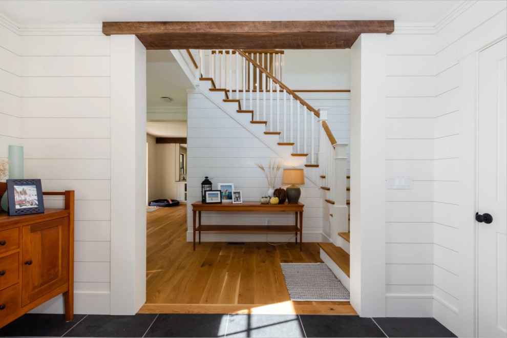 This is an example of a beach style entrance in Boston with medium hardwood flooring and brown floors.