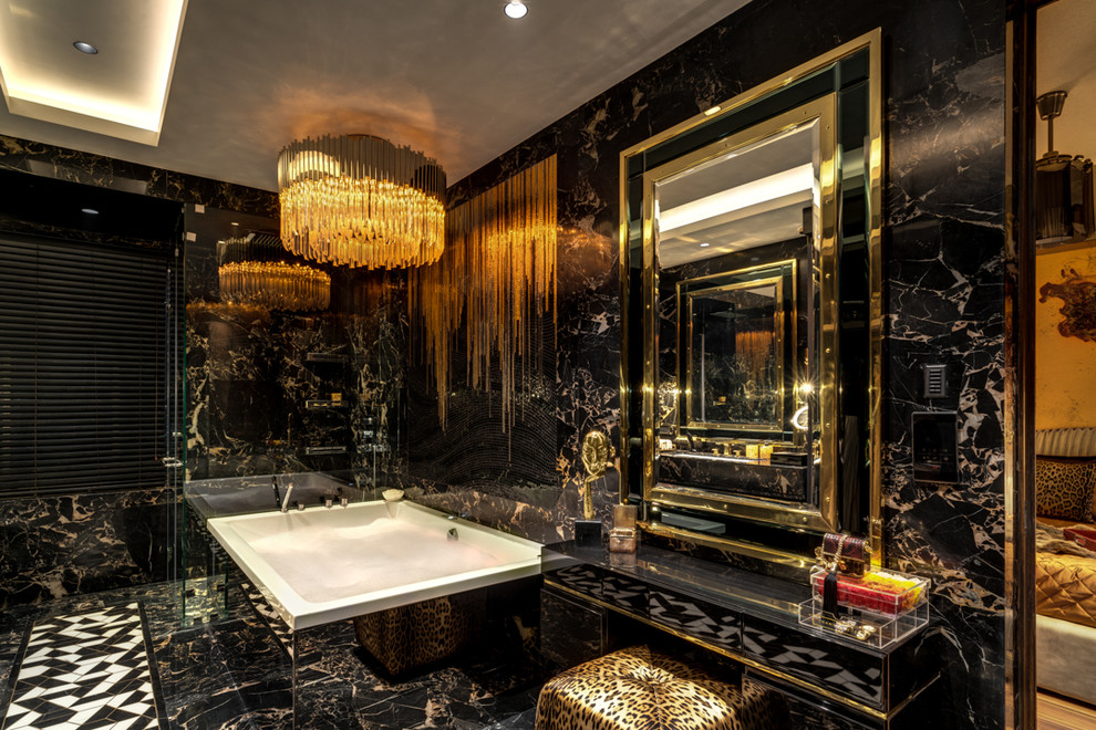 Photo of a mid-sized contemporary bathroom in Mumbai with a hot tub, a one-piece toilet, black tile, marble, black walls, marble floors, an undermount sink, marble benchtops, black floor, a hinged shower door and black benchtops.