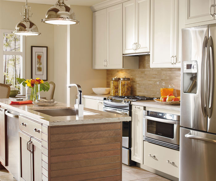 Inspiration for a mid-sized transitional single-wall ceramic tile eat-in kitchen remodel in Chicago with an undermount sink, recessed-panel cabinets, white cabinets, beige backsplash, stone tile backsplash, stainless steel appliances and an island