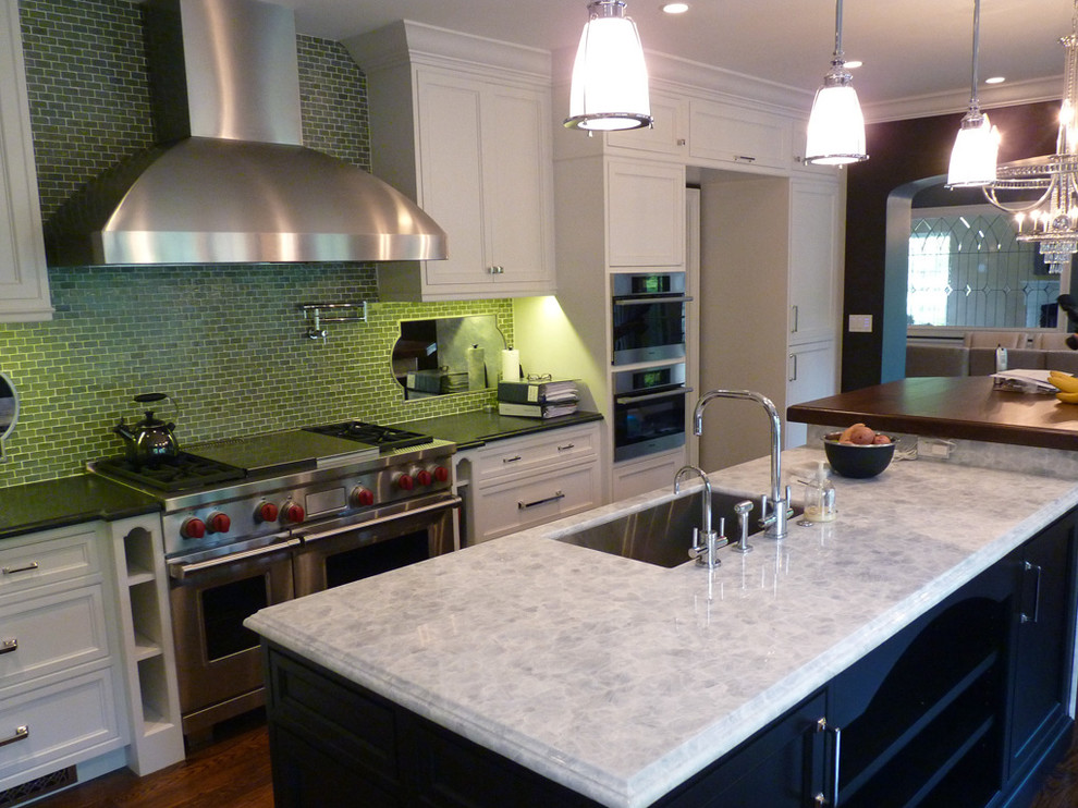 Photo of a traditional kitchen in Chicago with a single-bowl sink, recessed-panel cabinets, white cabinets, quartzite benchtops, green splashback, mosaic tile splashback and stainless steel appliances.