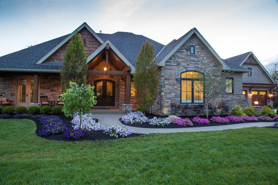 Design ideas for a large country one-storey brick brown exterior in Cincinnati.