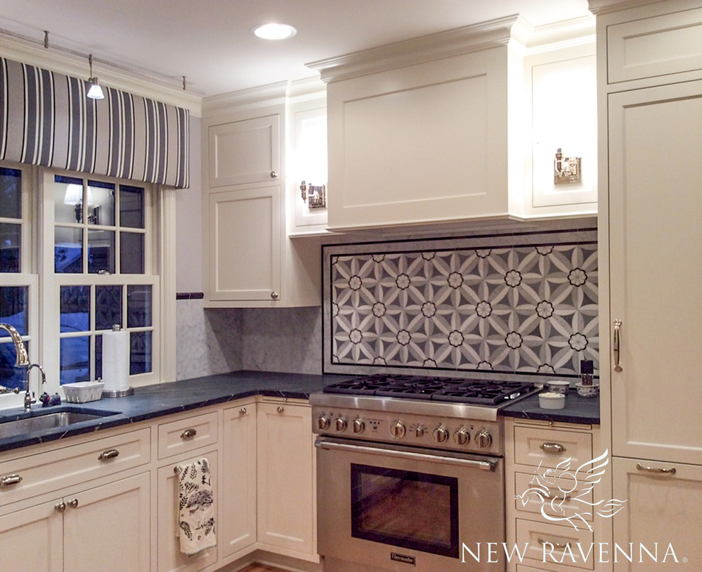 Example of a transitional home design design with recessed-panel cabinets, beige cabinets, black backsplash and mosaic tile backsplash