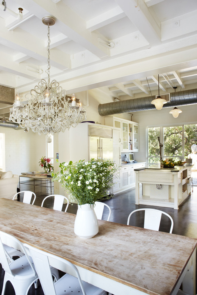 Photo of a large industrial open plan dining in Orange County with concrete floors, beige walls and no fireplace.