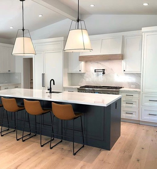 Large transitional l-shaped medium tone wood floor, beige floor and exposed beam eat-in kitchen photo in Miami with shaker cabinets, white cabinets, quartz countertops, white backsplash, quartz backsplash, paneled appliances, an island and white countertops