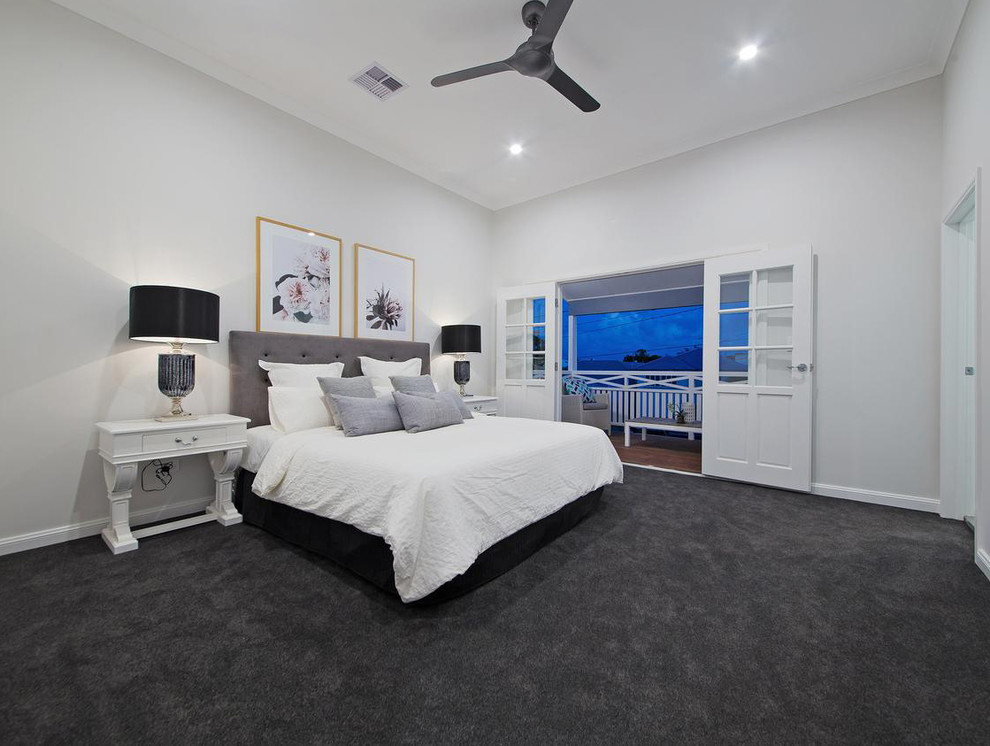 Large traditional master bedroom in Brisbane with grey walls, carpet and grey floor.