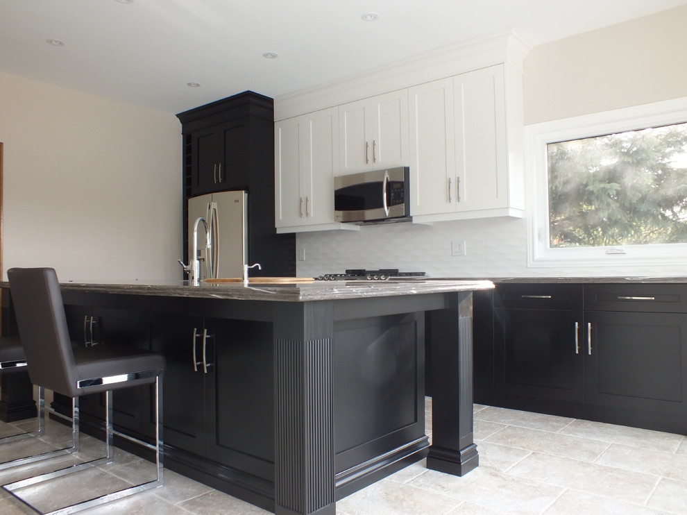 Inspiration for a large transitional galley ceramic tile enclosed kitchen remodel in Toronto with an undermount sink, shaker cabinets, black cabinets, granite countertops, white backsplash, ceramic backsplash, stainless steel appliances and an island