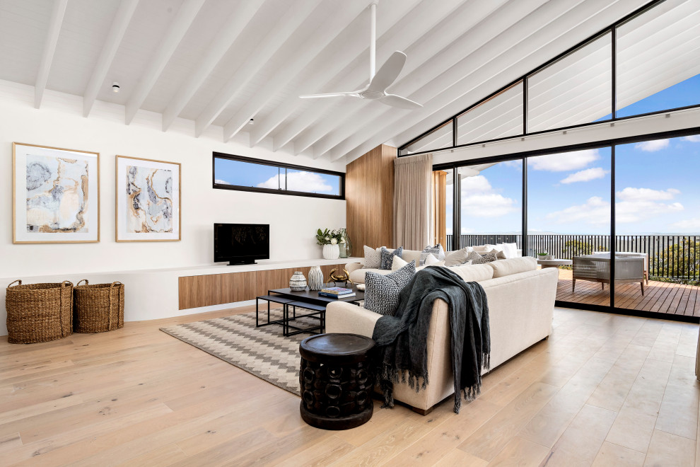 This is an example of a beach style family room in Sydney.