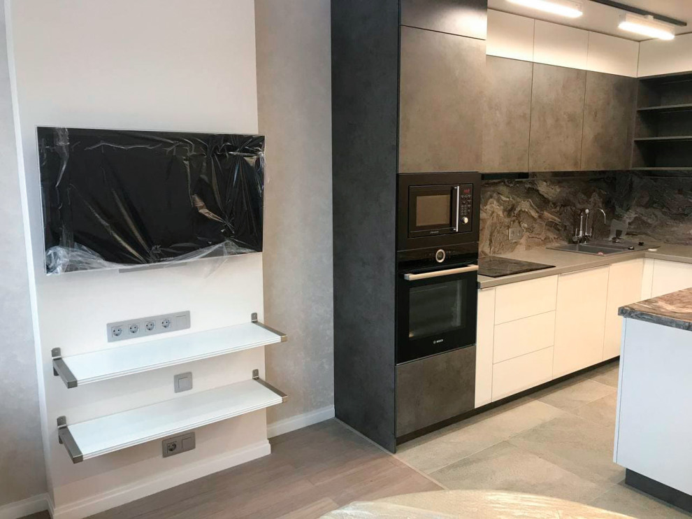Inspiration for a mid-sized contemporary l-shaped eat-in kitchen in Saint Petersburg with an undermount sink, flat-panel cabinets, grey cabinets, solid surface benchtops, black splashback, marble splashback, panelled appliances, laminate floors, with island, beige floor and black benchtop.
