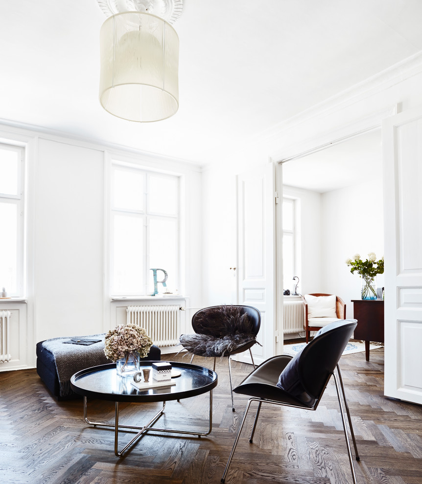 Photo of a scandinavian enclosed living room in Other with white walls and dark hardwood floors.