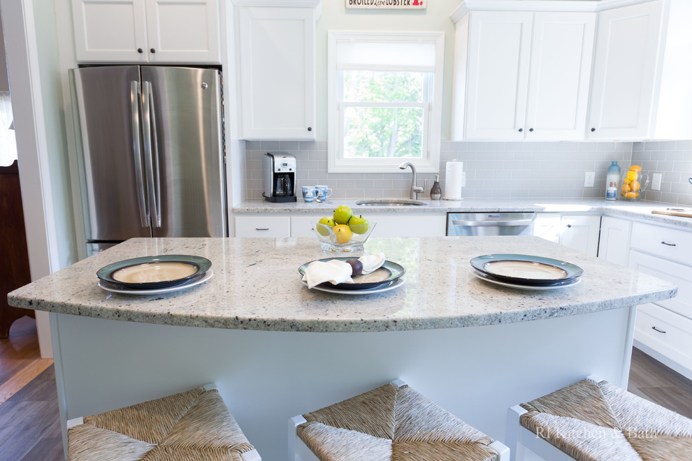 Inspiration for a large transitional l-shaped porcelain tile eat-in kitchen remodel in Providence with an undermount sink, recessed-panel cabinets, white cabinets, granite countertops, gray backsplash, ceramic backsplash, stainless steel appliances, green walls and an island
