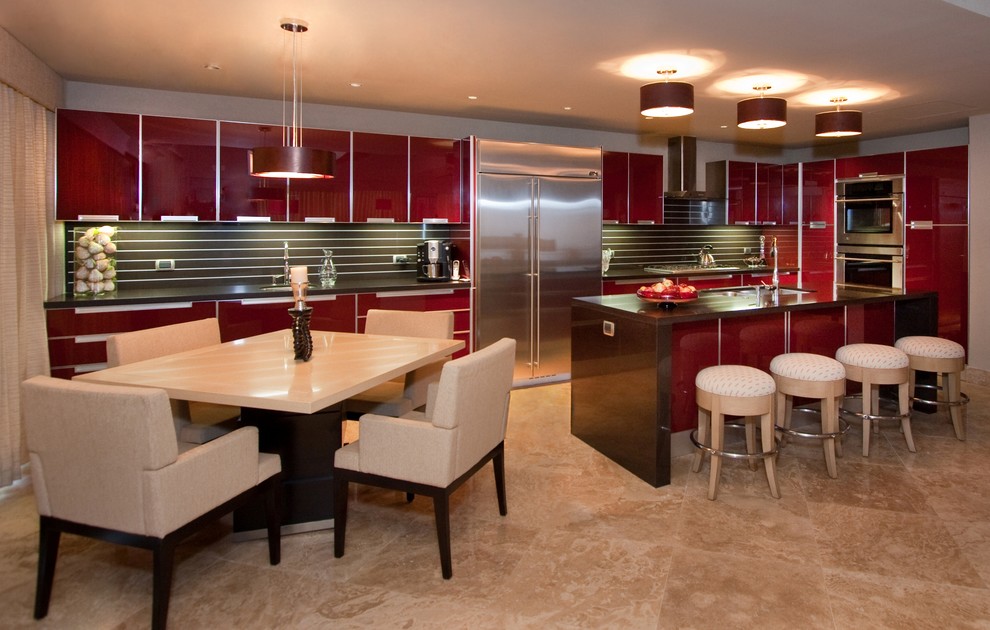 Mid-sized contemporary l-shaped open plan kitchen in Other with stainless steel appliances, red cabinets, an undermount sink, glass-front cabinets, quartz benchtops, brown splashback, marble floors, stone slab splashback, a peninsula, beige floor and brown benchtop.