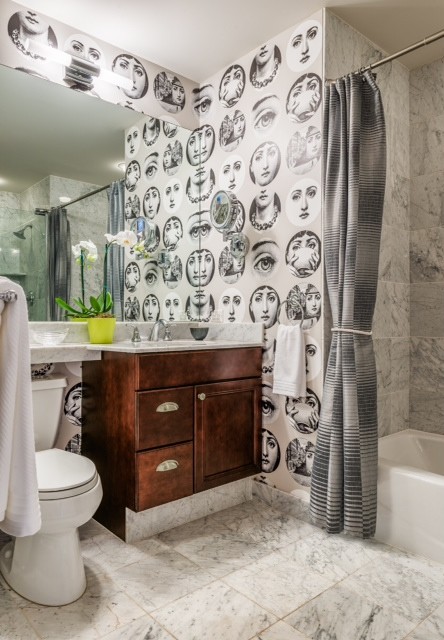 This is an example of a small eclectic master bathroom in Philadelphia with an integrated sink, raised-panel cabinets, dark wood cabinets, marble benchtops, an alcove tub, a corner shower, a one-piece toilet, gray tile, stone tile, multi-coloured walls and marble floors.