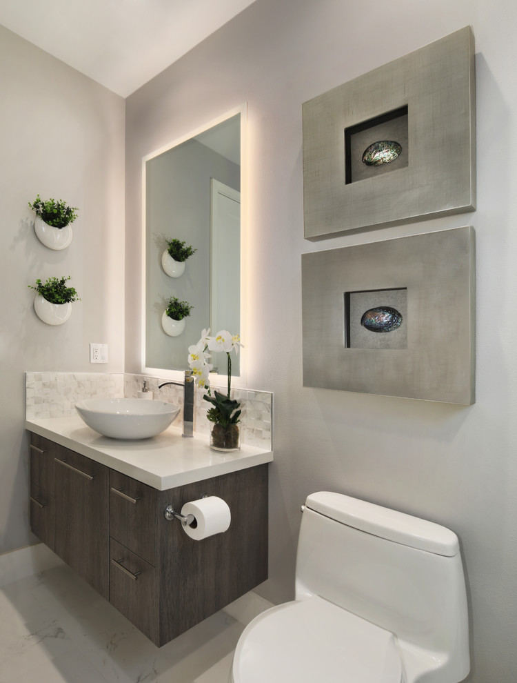 Small modern 3/4 bathroom in Orange County with flat-panel cabinets, dark wood cabinets, an alcove shower, a one-piece toilet, white tile, porcelain tile, grey walls, porcelain floors, a vessel sink, engineered quartz benchtops, white floor, a hinged shower door and white benchtops.