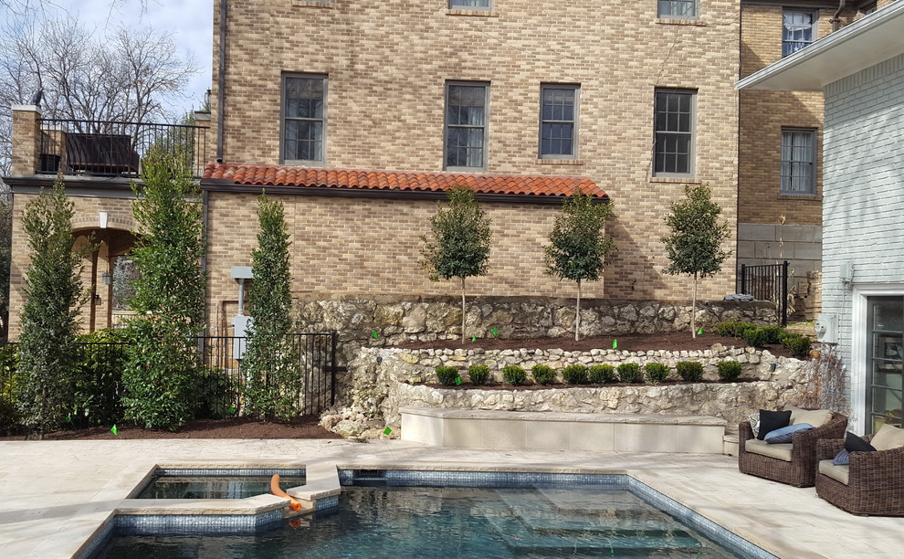 This is an example of a small traditional backyard partial sun garden for winter in Dallas with natural stone pavers.