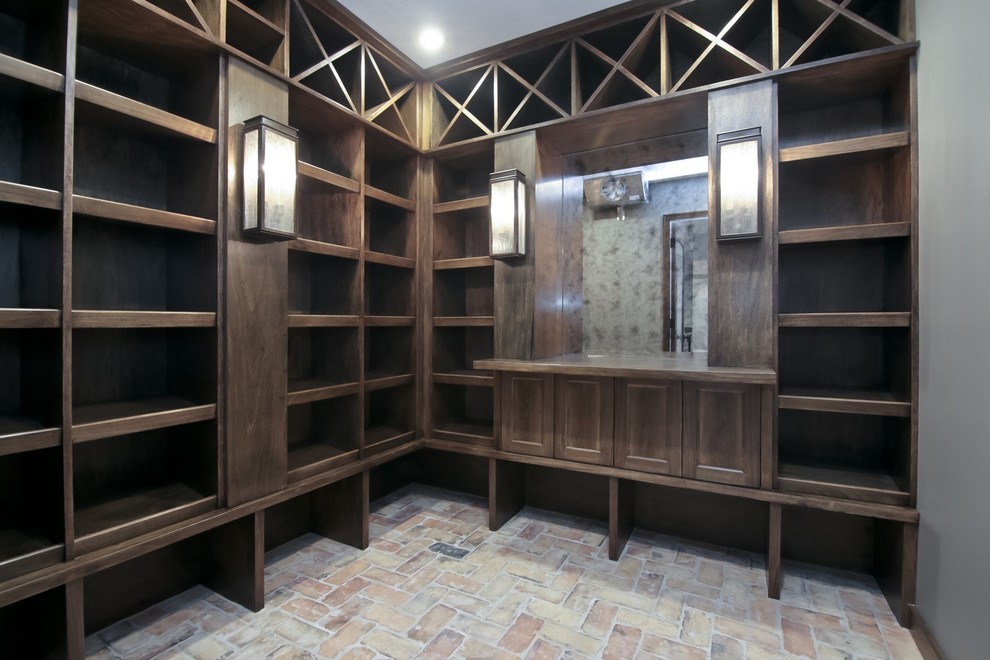 Photo of a mid-sized transitional wine cellar in Chicago with brick floors, storage racks and multi-coloured floor.