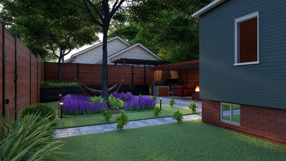 Foto di un giardino design esposto a mezz'ombra di medie dimensioni e dietro casa in estate con pavimentazioni in mattoni e recinzione in PVC