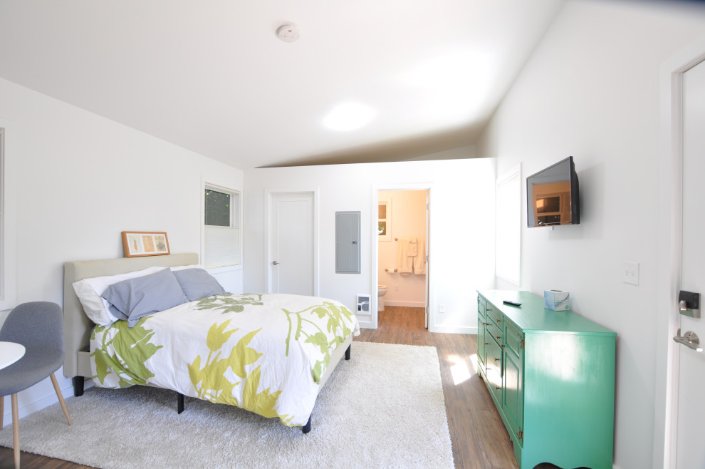 This is an example of a small transitional loft-style bedroom in Seattle with white walls and vaulted.