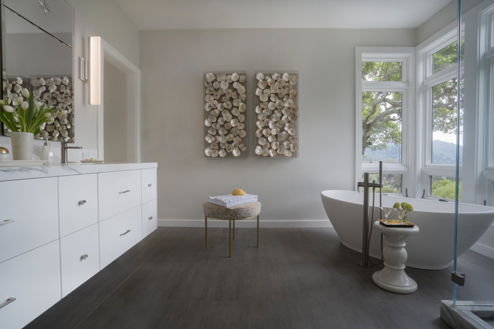 Design ideas for a large contemporary master bathroom in San Francisco with flat-panel cabinets, white cabinets, a freestanding tub, a corner shower, marble, grey walls, ceramic floors, an undermount sink, marble benchtops, grey floor, a hinged shower door, white benchtops, a double vanity and a built-in vanity.