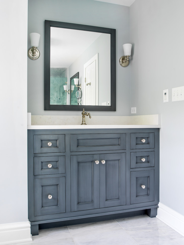 This is an example of a mid-sized traditional master bathroom in Chicago with an undermount sink, quartzite benchtops, a claw-foot tub, an alcove shower, a two-piece toilet, gray tile, stone tile, blue walls, marble floors, furniture-like cabinets, blue cabinets, white floor, a hinged shower door, white benchtops, a niche, a single vanity and a built-in vanity.