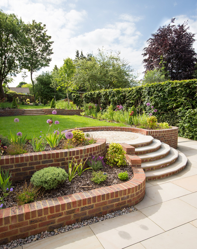 Inspiration for a large traditional full sun formal garden in Cheshire with a retaining wall.
