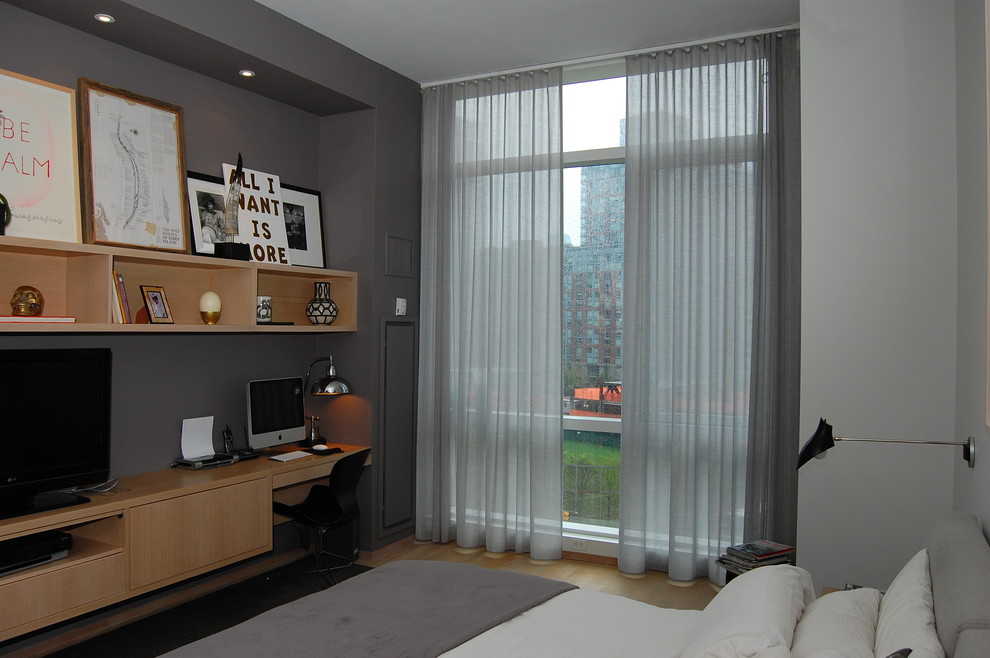 Inspiration for a contemporary bedroom in New York with grey walls and light hardwood floors.