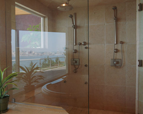 Inspiration for a contemporary bathroom in Seattle with a double shower, beige tile and stone tile.