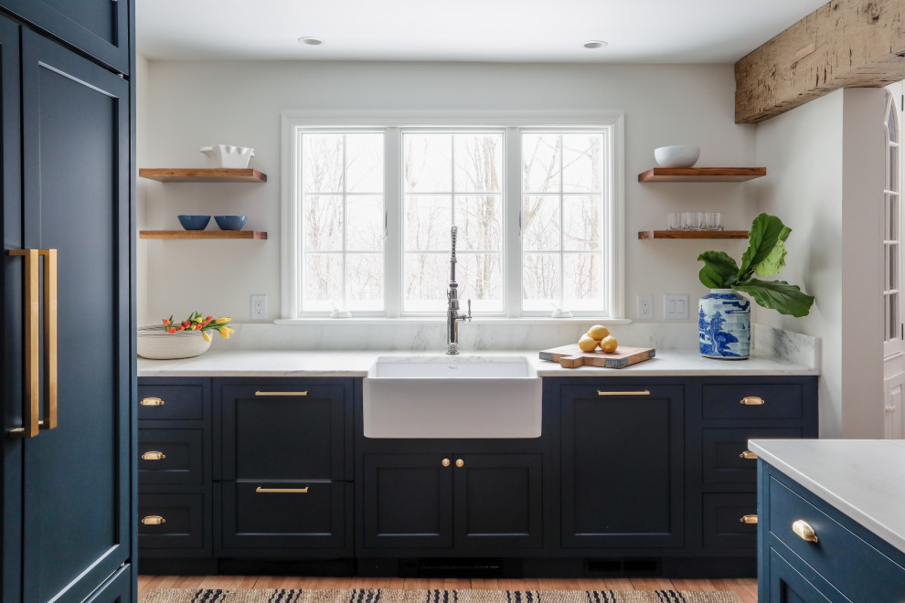 Inspiration for a small transitional u-shaped eat-in kitchen in New York with a farmhouse sink, shaker cabinets, blue cabinets, marble benchtops, white splashback, ceramic splashback, panelled appliances, marble floors, no island, beige floor, white benchtop and exposed beam.