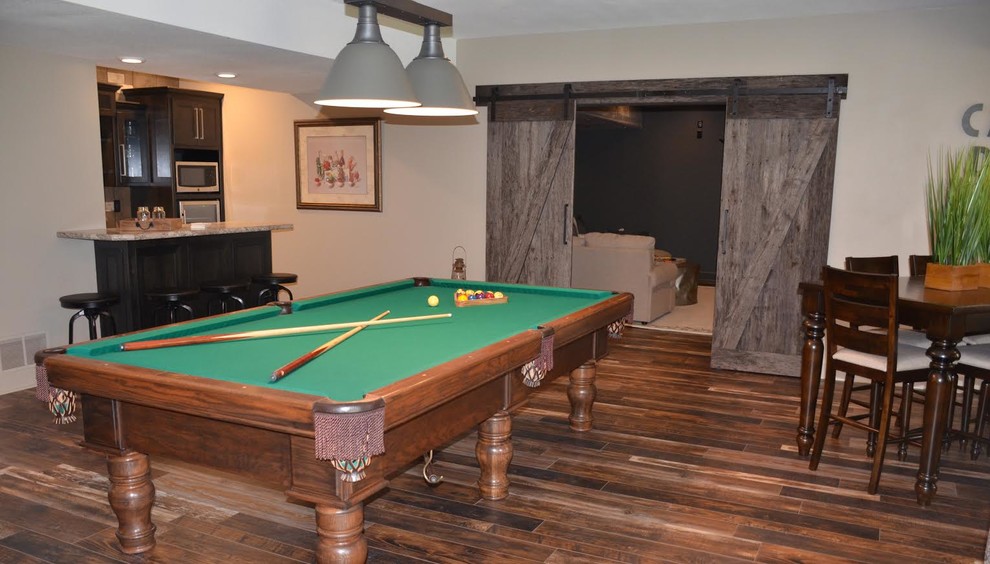 Photo of a large transitional fully buried basement in Other with beige walls, medium hardwood floors, no fireplace, brown floor and a game room.