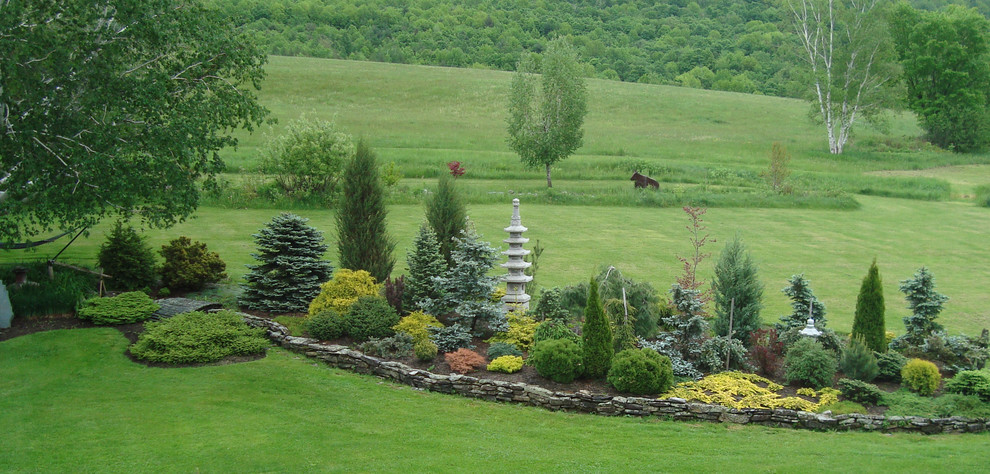 This is an example of a large eclectic backyard landscaping in Boston.