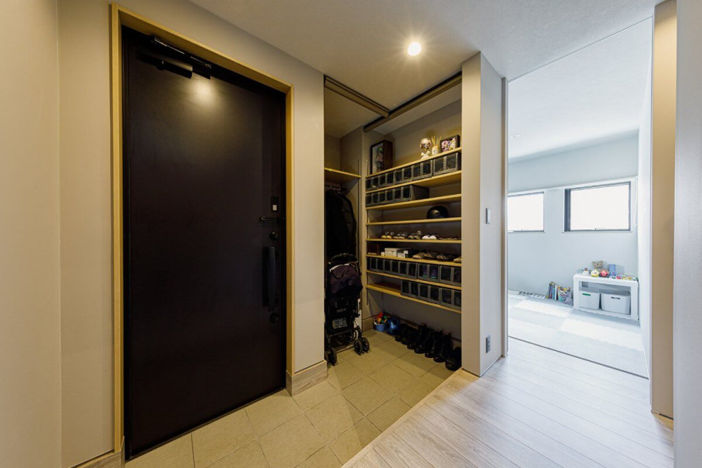 Inspiration for a medium sized industrial hallway in Tokyo Suburbs with a single front door, a black front door, white walls, light hardwood flooring, grey floors, a wallpapered ceiling and wallpapered walls.