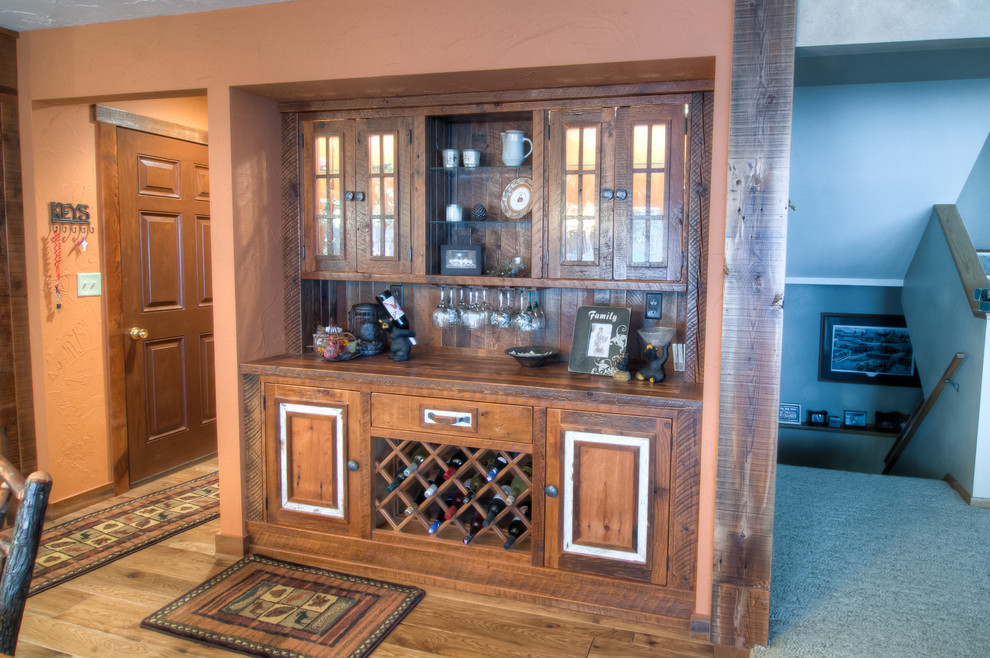 Inspiration for a rustic u-shaped eat-in kitchen remodel with an undermount sink, raised-panel cabinets, granite countertops and stainless steel appliances