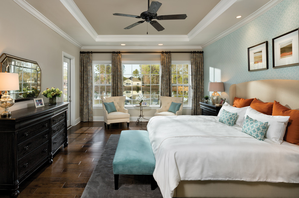 Photo of a large transitional master bedroom in Charleston with beige walls and dark hardwood floors.