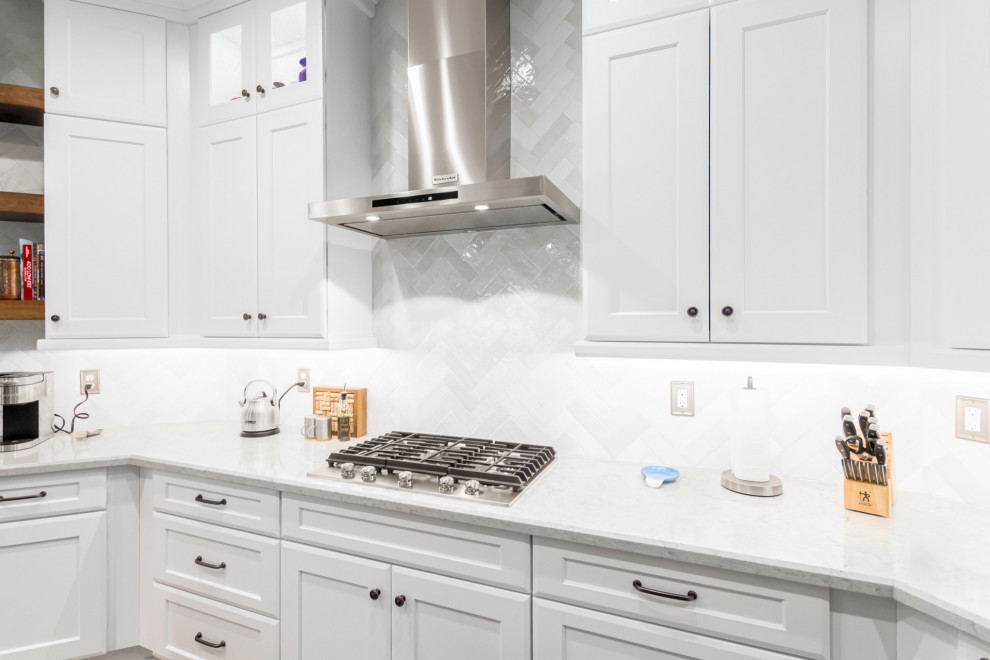 Inspiration for a transitional kitchen remodel in Phoenix with a farmhouse sink, shaker cabinets, white cabinets, white backsplash, subway tile backsplash and white countertops