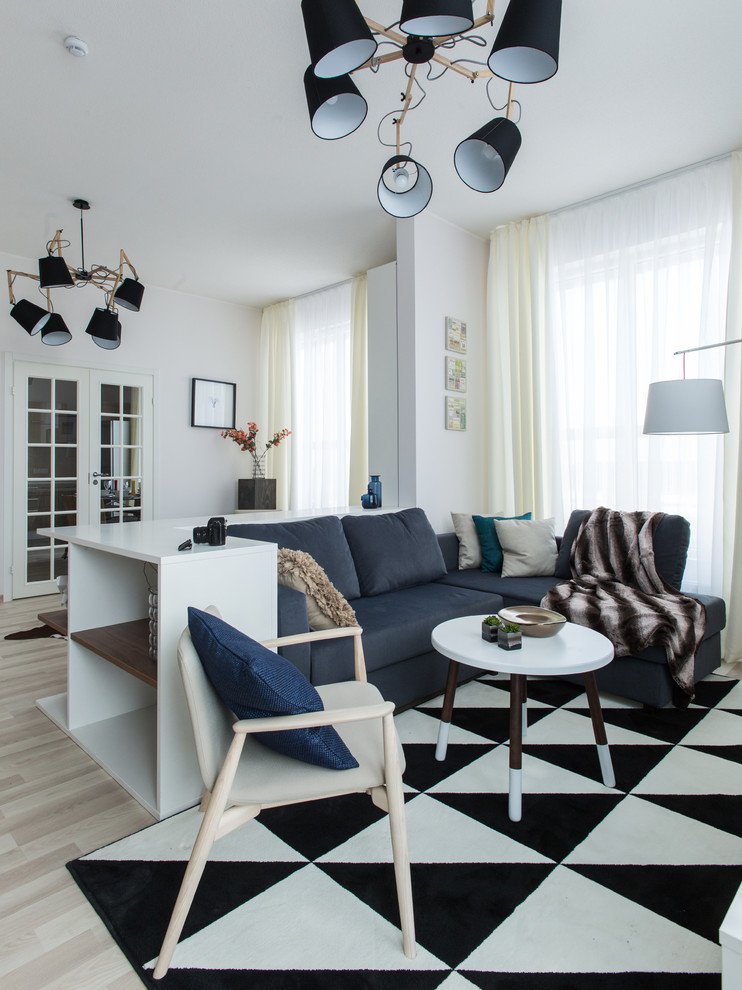 Inspiration for a scandinavian living room in Other with white walls and light hardwood floors.