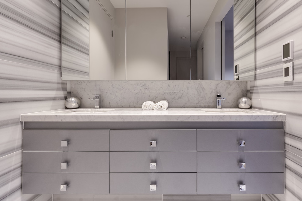 Photo of a mid-sized industrial bathroom in Brisbane with beaded inset cabinets, beige cabinets, a freestanding tub, an open shower, a one-piece toilet, multi-coloured tile, marble, multi-coloured walls, marble floors, a drop-in sink, marble benchtops, beige floor and an open shower.