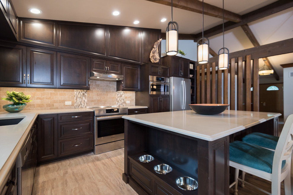 Example of a transitional cork floor kitchen design in St Louis with an undermount sink, raised-panel cabinets, dark wood cabinets, beige backsplash, stainless steel appliances and an island