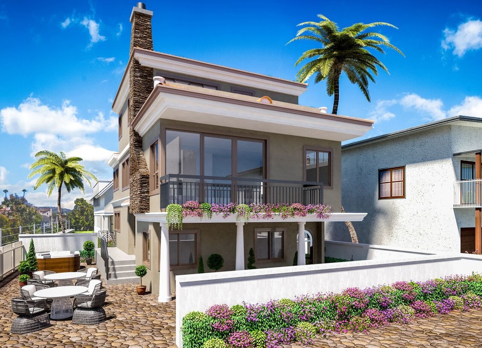 Photo of a mid-sized beach style two-storey white exterior in Orange County with stone veneer and a flat roof.