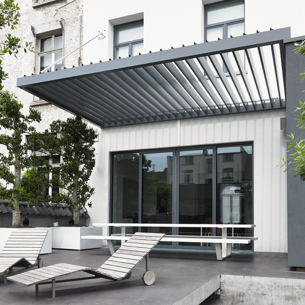 Mid-sized contemporary patio in New York with a pergola.