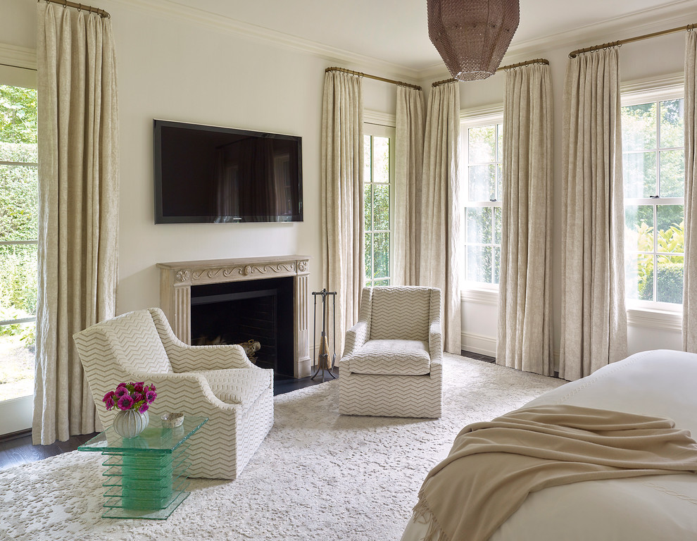 Design ideas for a large transitional master bedroom in New York with white walls, dark hardwood floors, a standard fireplace and a stone fireplace surround.