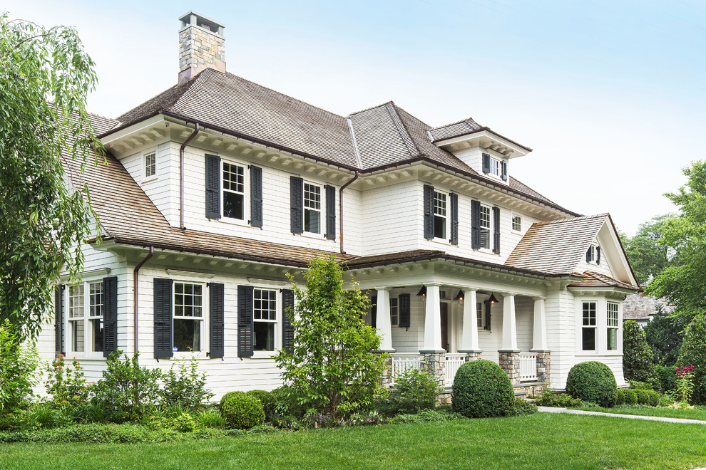 Inspiration for a large craftsman white two-story vinyl exterior home remodel in New York with a hip roof
