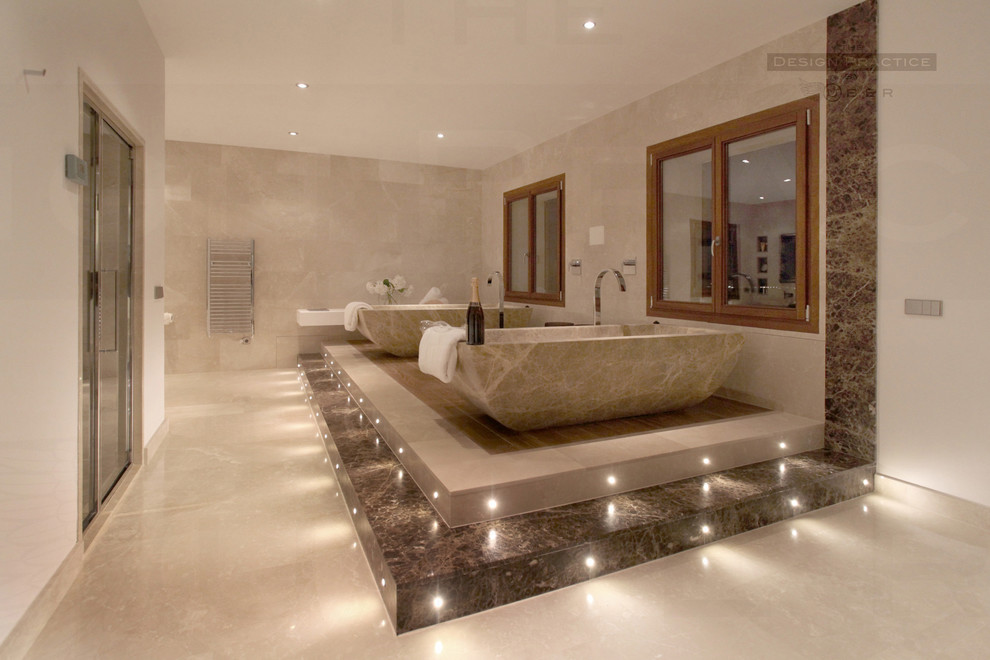 Design ideas for a large mediterranean master bathroom in Other with a freestanding tub, beige tile and travertine floors.