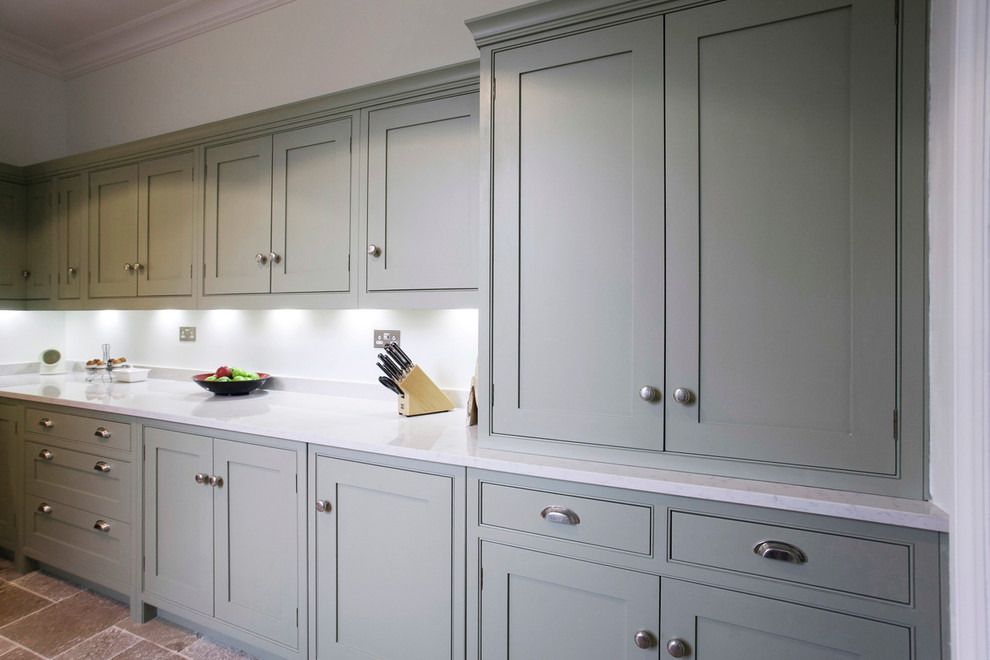 Photo of a mid-sized contemporary galley separate kitchen in Kent with a farmhouse sink, shaker cabinets, green cabinets, quartzite benchtops, white splashback, subway tile splashback, coloured appliances, limestone floors and white benchtop.