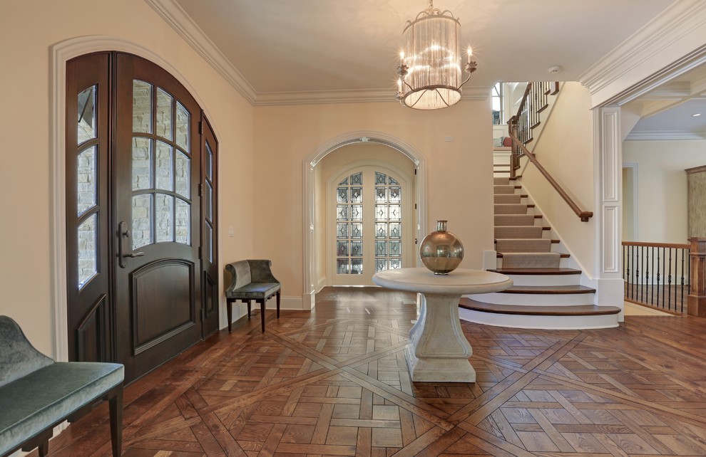 Photo of a large traditional entryway in Chicago with beige walls, medium hardwood floors, a single front door and a dark wood front door.